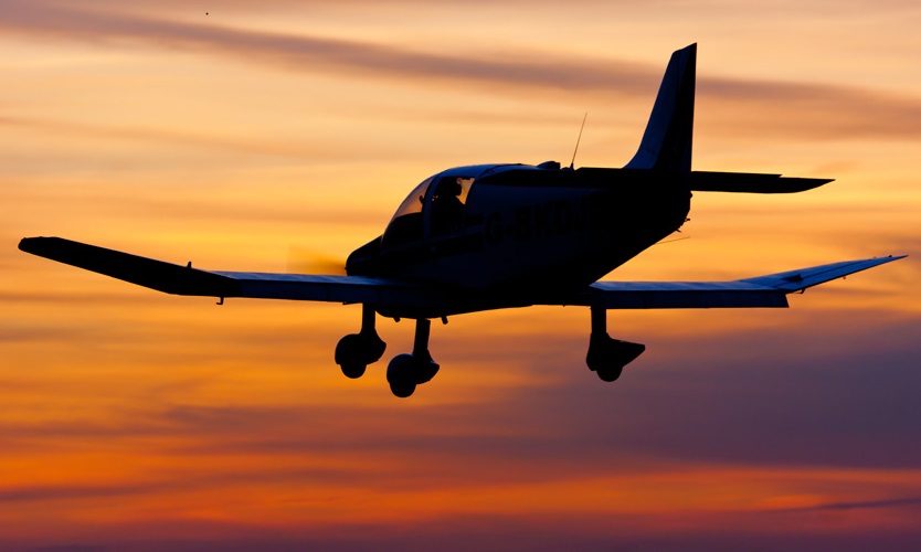 A Cotswold Aero Club aircraft on approach to Gloucestershire at sunset
